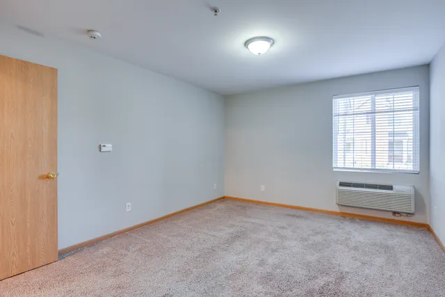 a view of an empty room with a window