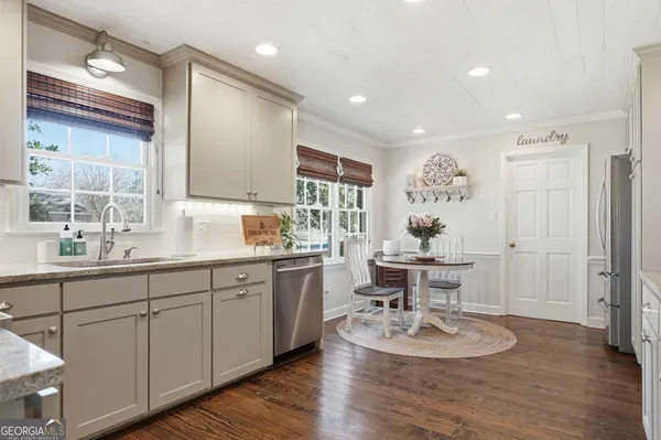 a bedroom with bed and wooden floor