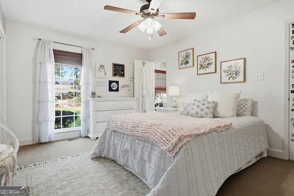 a bedroom with bed and a window