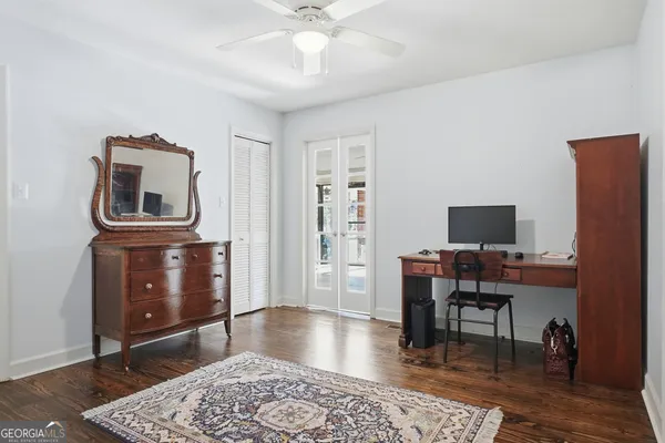a living room with wooden floor furniture and a floor to ceiling window