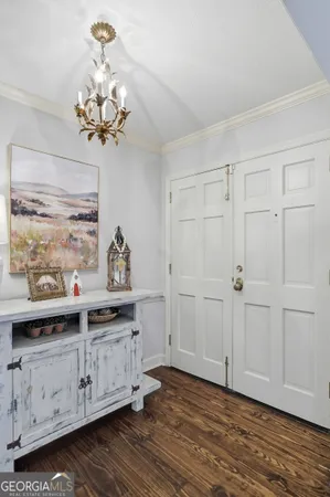 a view of a chandelier fan and wooden floor
