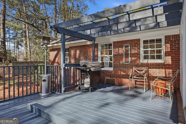 a view of yard from deck with patio