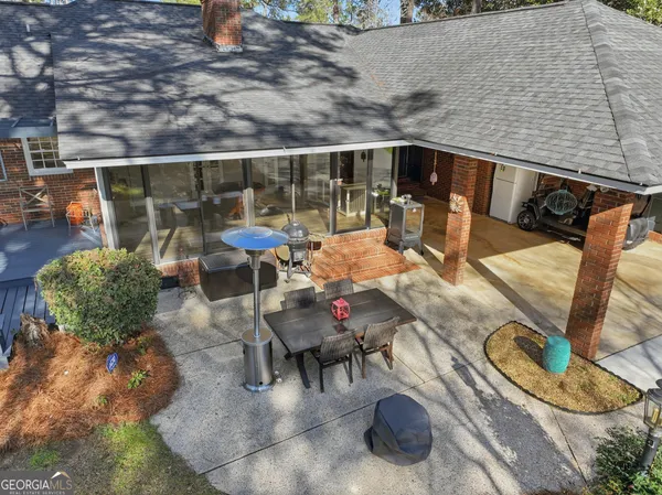 a front view of a house with swimming pool having outdoor seating