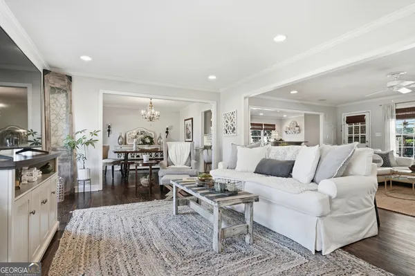 a living room with furniture wooden floor and a rug