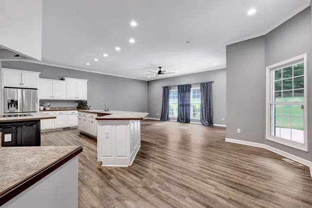 a bathroom with a granite countertop sink a mirror and a bathtub