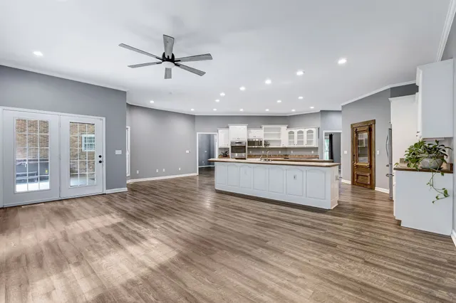 a bathroom with a granite countertop sink and a large mirror