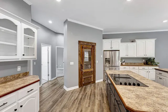 a spacious bathroom with a double vanity sink a mirror and a shower