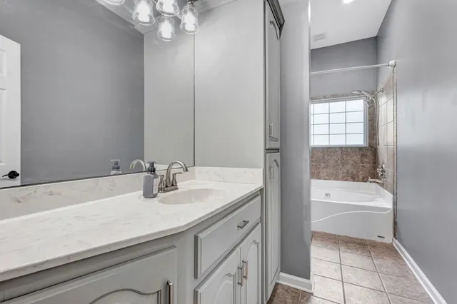 a view of a room with wooden floor ceiling fan and windows