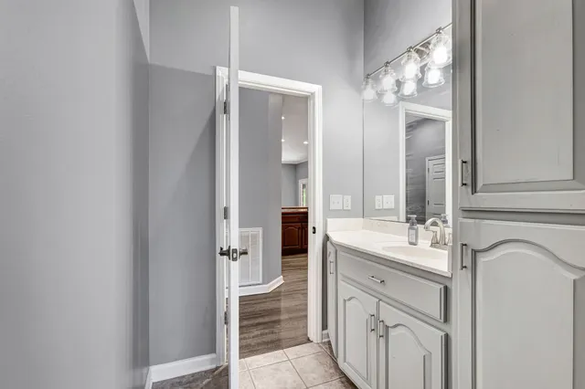 a bathroom with a toilet a sink and mirror