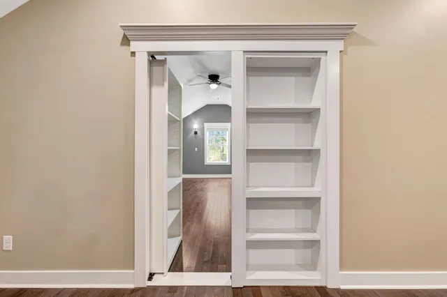 a backyard of a house with lots of green space and chair