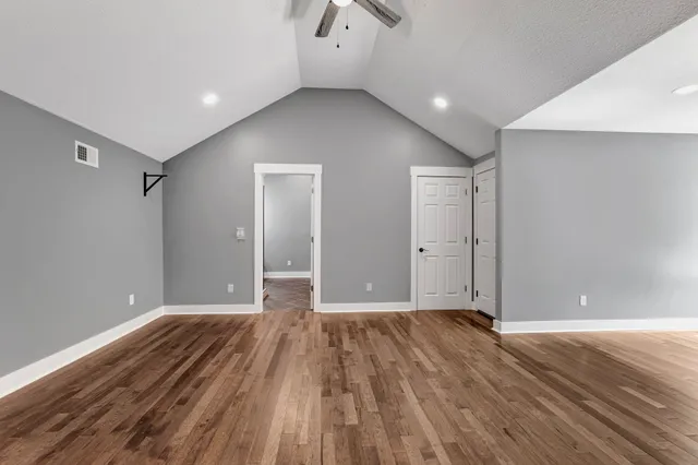a view of a lush green forest with trees and some houses