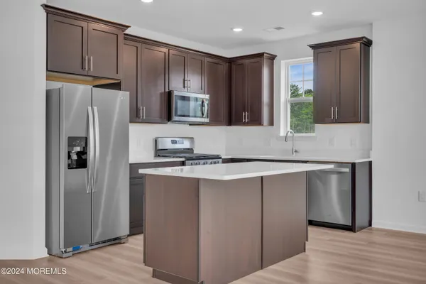 a kitchen with stainless steel appliances granite countertop a refrigerator and a sink