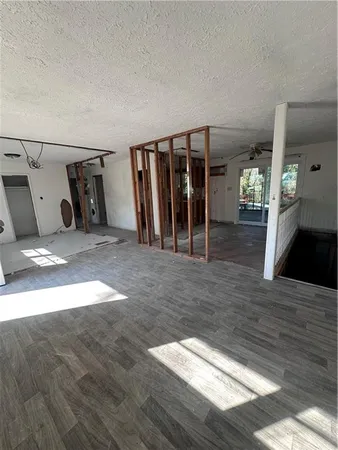 a view of a livingroom with wooden floor and stairs