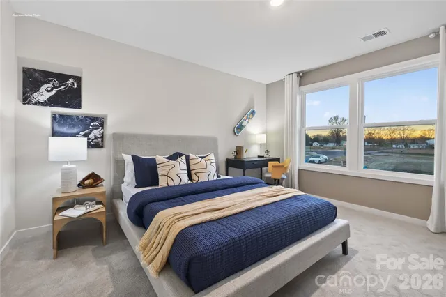 a bedroom with a bed and a table