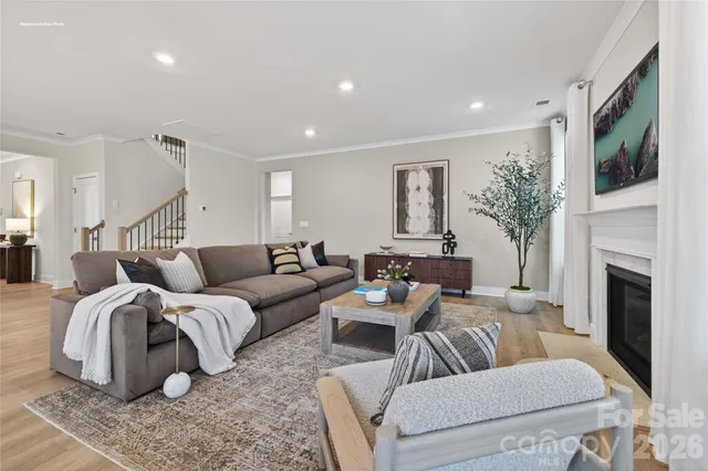 a living room with furniture fireplace and flat screen tv