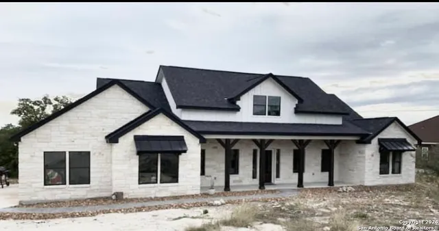 a view of a house with wooden fence