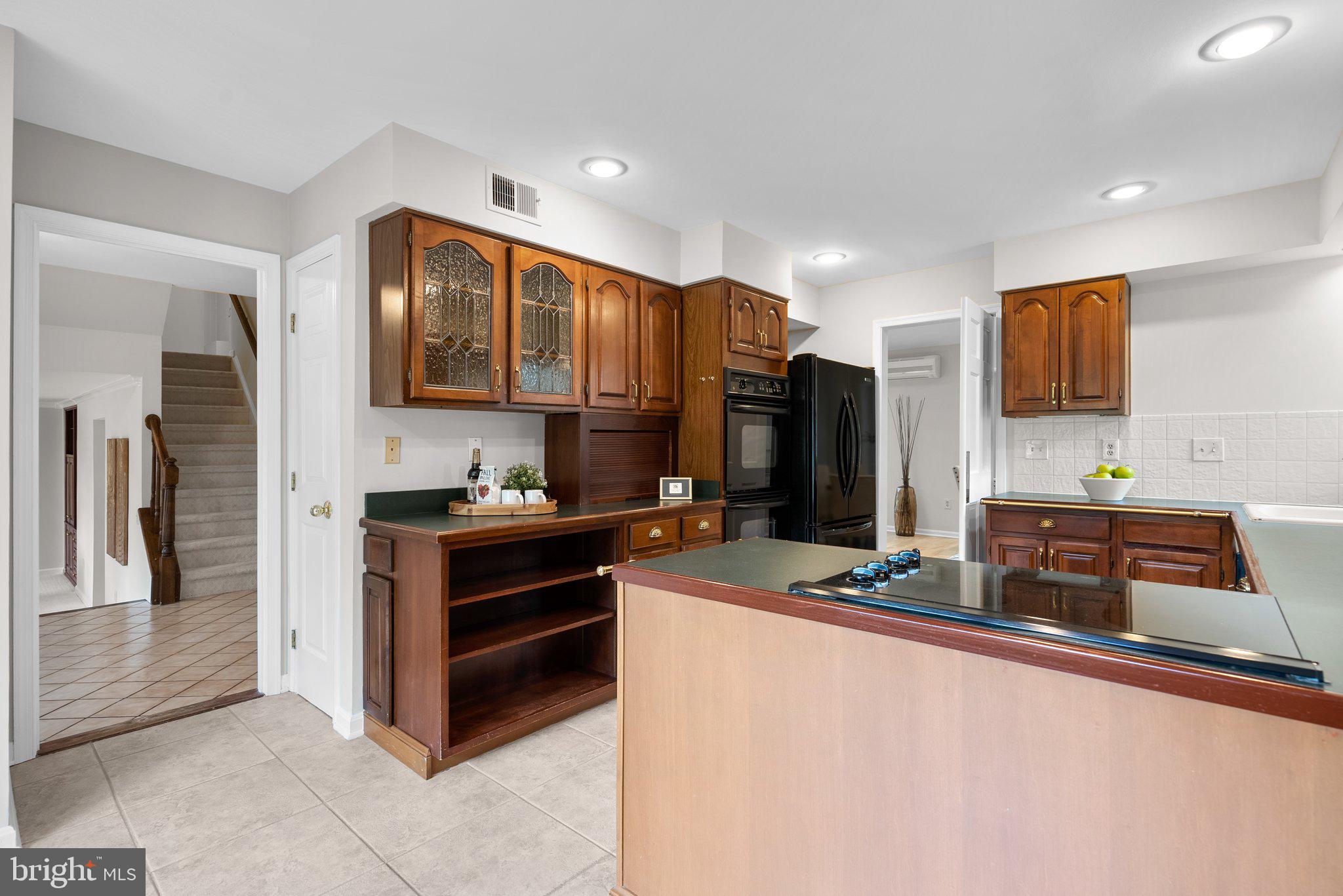 14620 Jaystone Drive Silver Spring, MD 20905 - Photo 15 of 52 a kitchen with stainless steel appliances a refrigerator and a stove top oven