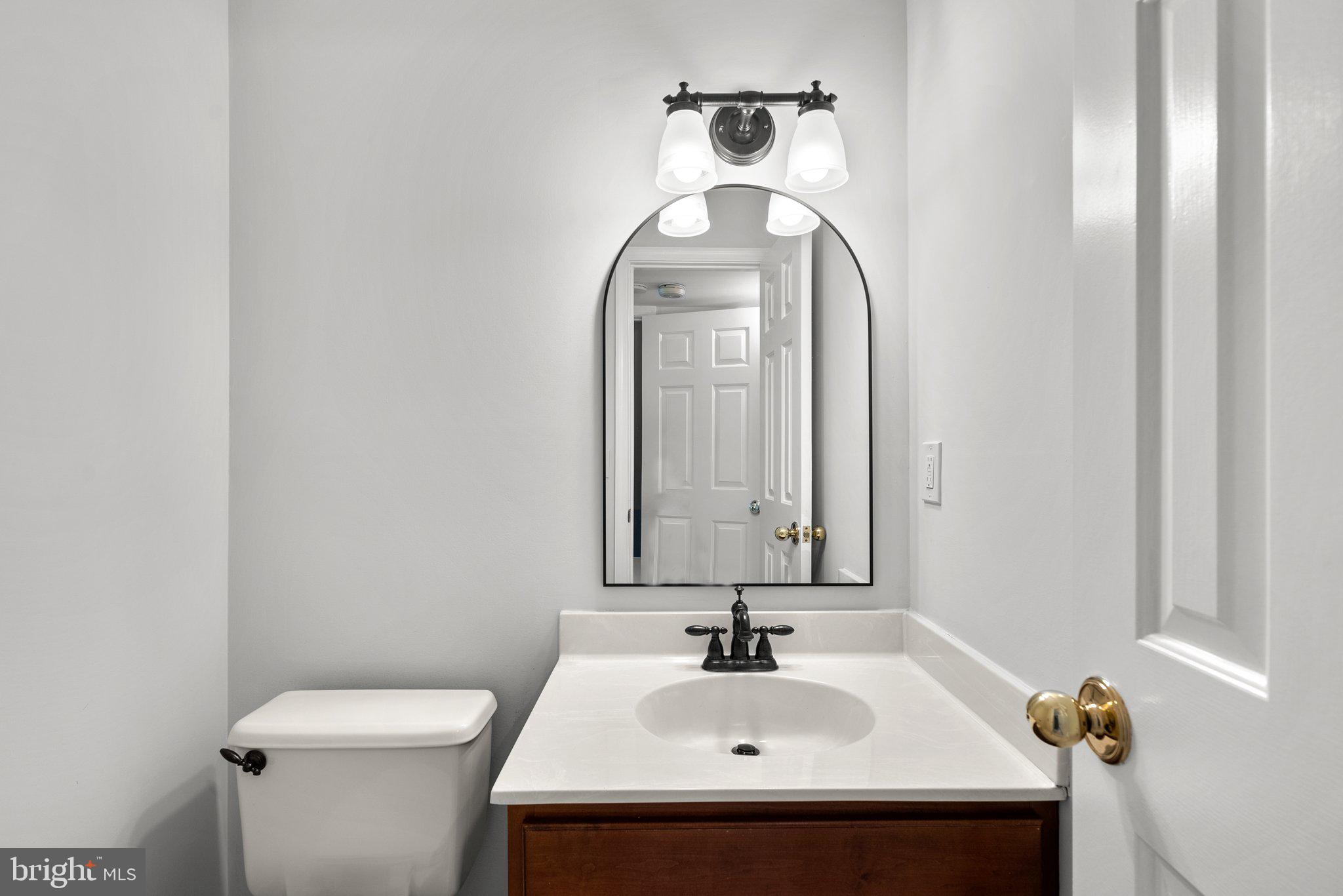 14620 Jaystone Drive Silver Spring, MD 20905 - Photo 20 of 52 a bathroom with a toilet sink and mirror
