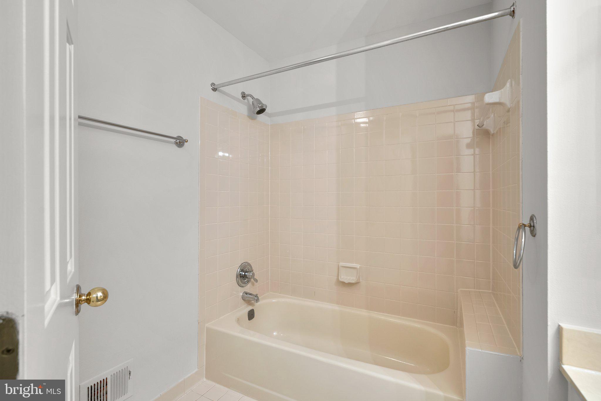14620 Jaystone Drive Silver Spring, MD 20905 - Photo 30 of 52 a bathroom with a shower and a bath tub