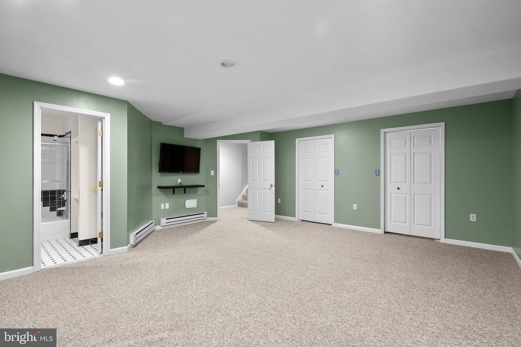 14620 Jaystone Drive Silver Spring, MD 20905 - Photo 44 of 52 an empty room with windows and a flat screen tv
