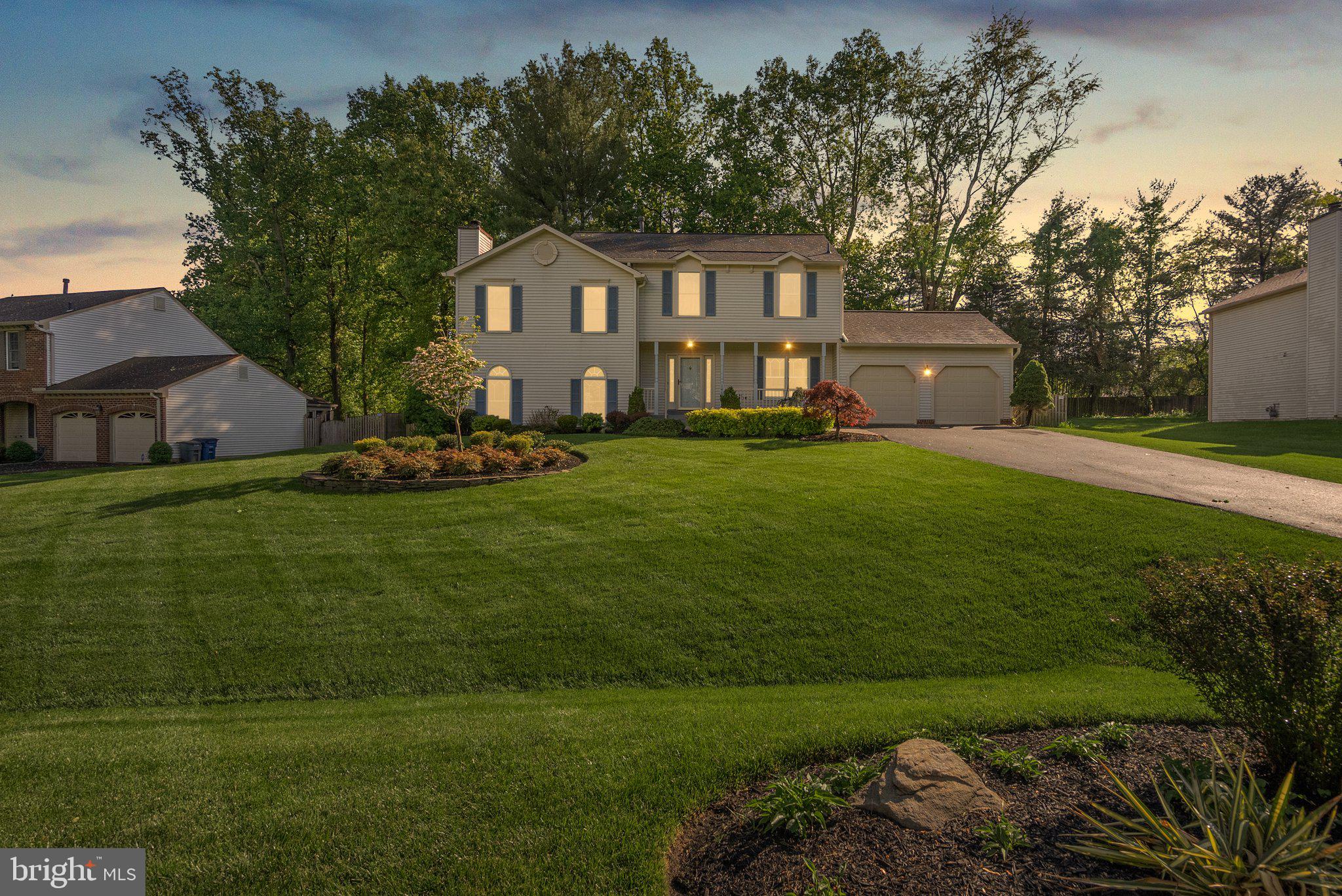 14620 Jaystone Drive Silver Spring, MD 20905 - Photo 51 of 52 a front view of a house with a garden and trees