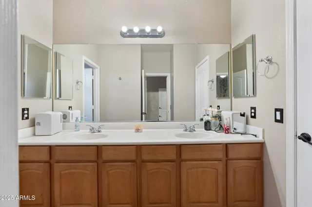 a bathroom with a double vanity sink mirror and double