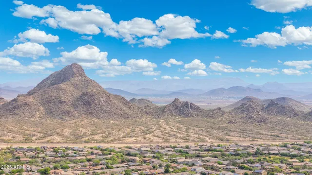 a view of a brick house with a mountain in the background