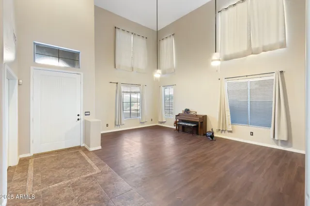 a view of a livingroom with wooden floor and a ceiling fan