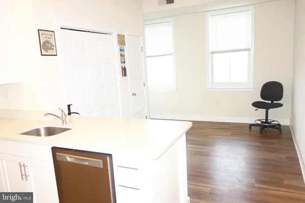 a view of a kitchen with a sink and a window