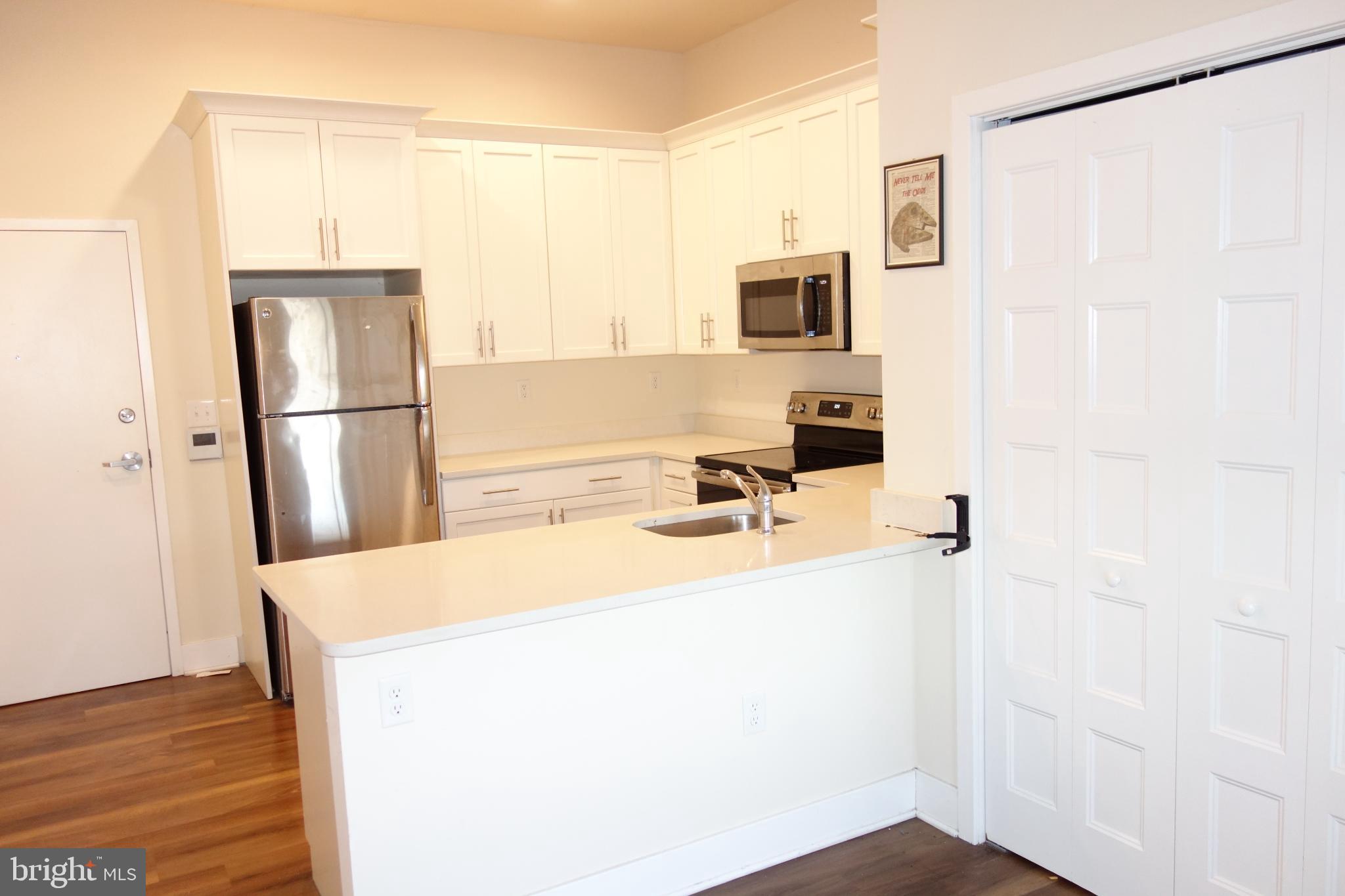 210 South Mill Road, Unit 203 Kennett Square, PA 19348 - Photo 2 of 5 Modern kitchen with sleek finishes.