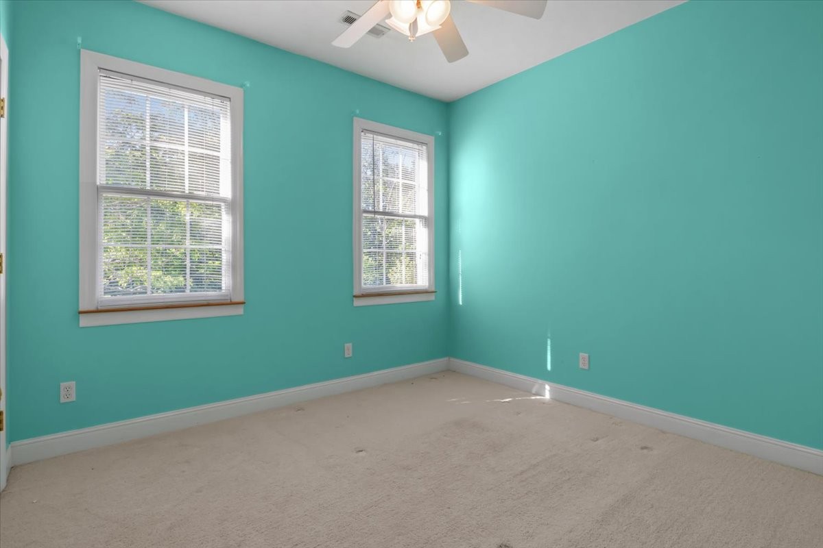 2440 Maple Grove Road Dickson, TN 37055 - Photo 28 of 99 an empty room with windows and chandelier fan
