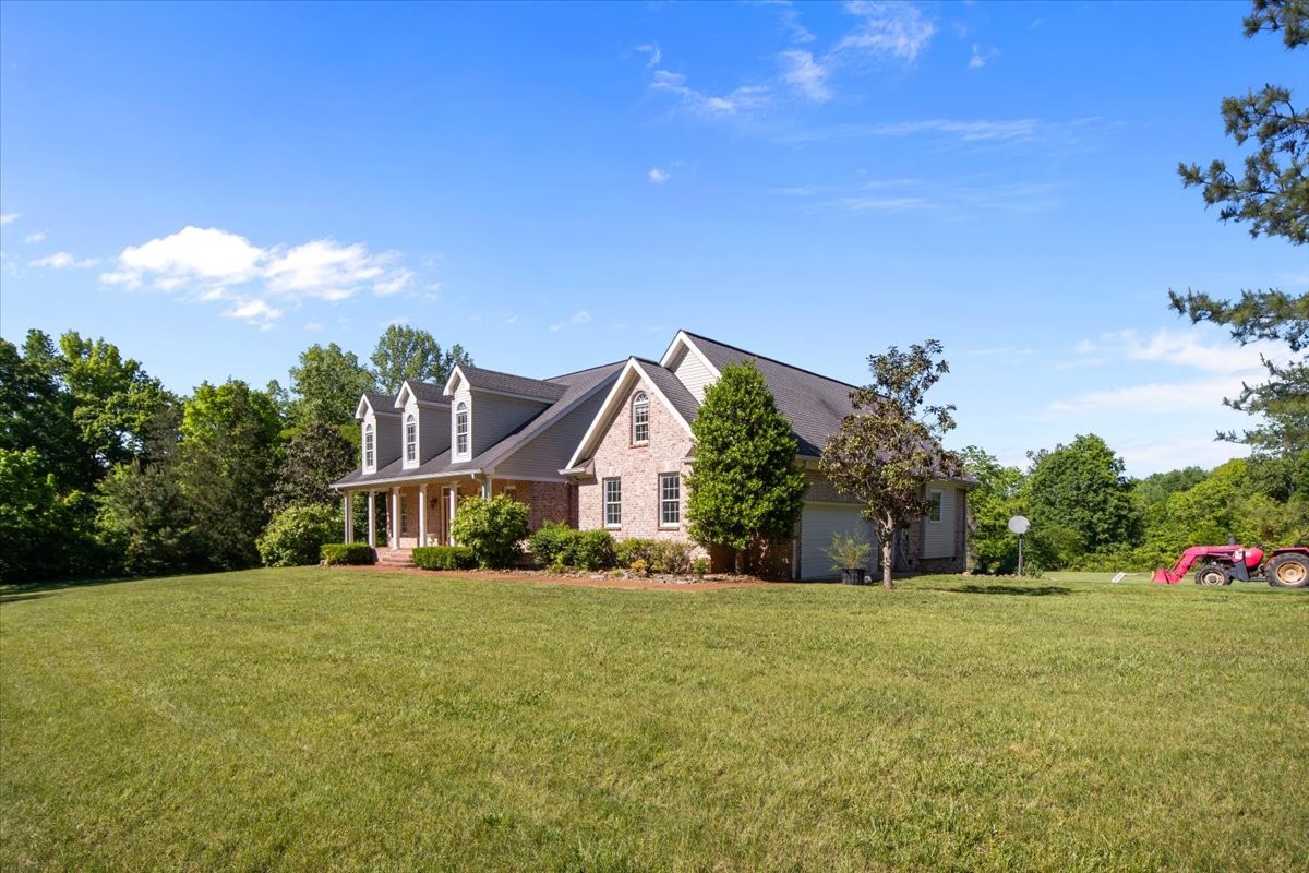 2440 Maple Grove Road Dickson, TN 37055 - Photo 3 of 99 a front view of house with yard and trees in the background