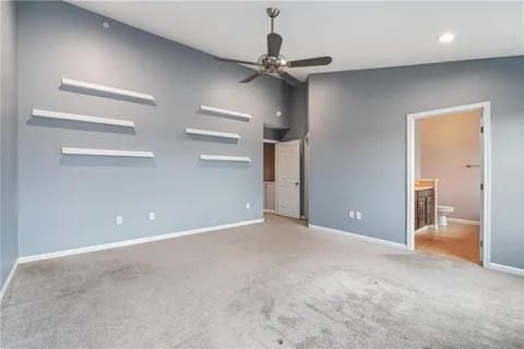 en view of an empty room and a ceiling fan