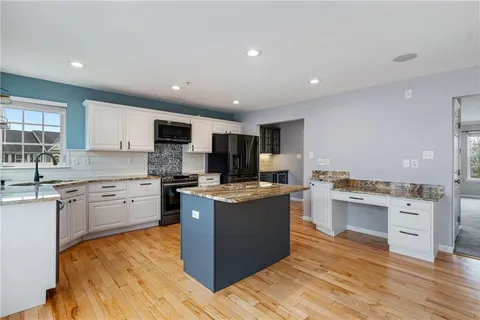 a kitchen with a stove top oven and cabinets