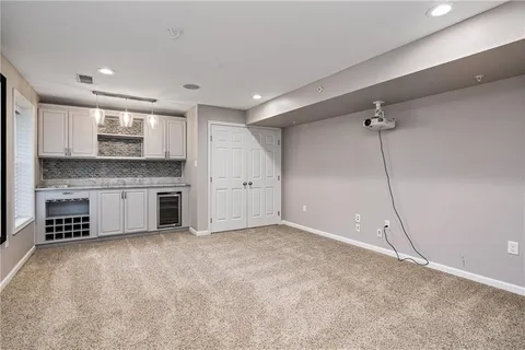 a view of a kitchen with a sink and a refrigerator