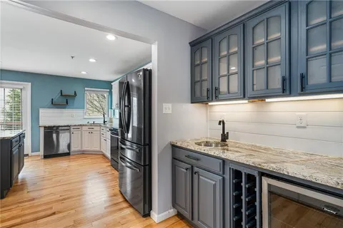 a kitchen with a refrigerator sink and cabinets