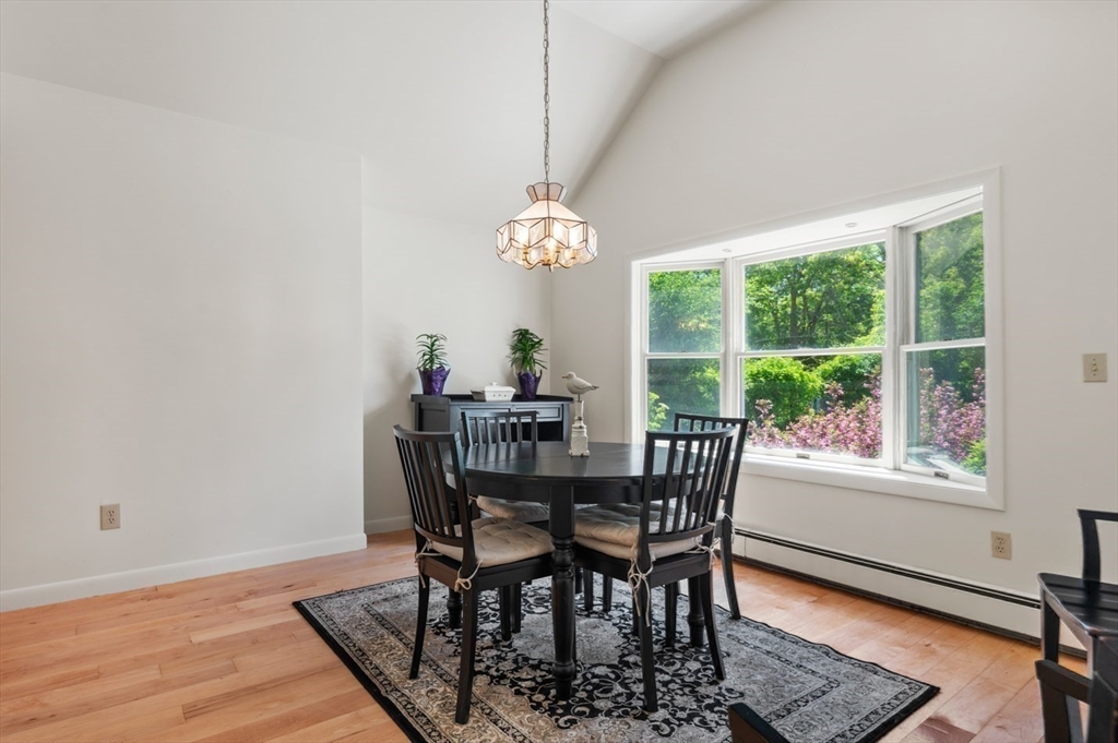 7 Bray Street Gloucester, MA 01930 - Photo 11 of 26 a dining room with furniture a rug and a floor to ceiling window
