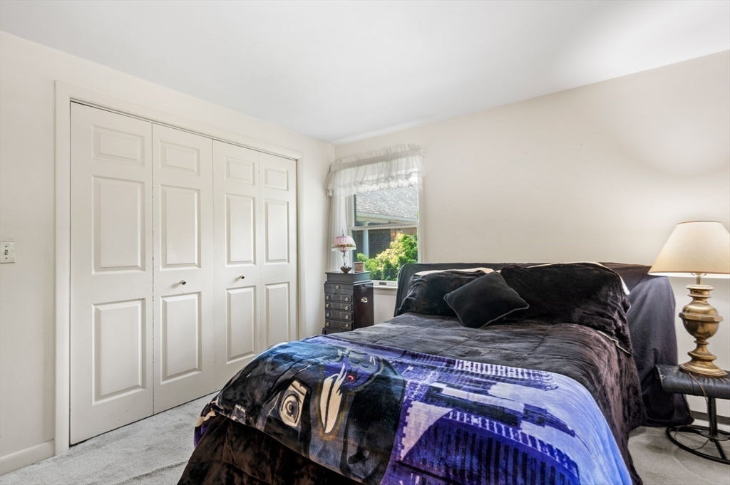 7 Bray Street Gloucester, MA 01930 - Photo 12 of 26 a bedroom with a bed and a lamp