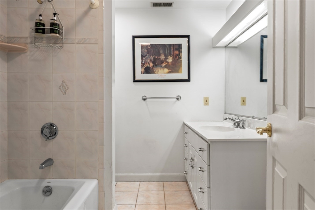 7 Bray Street Gloucester, MA 01930 - Photo 13 of 26 a bathroom with a double vanity sink mirror and bathtub