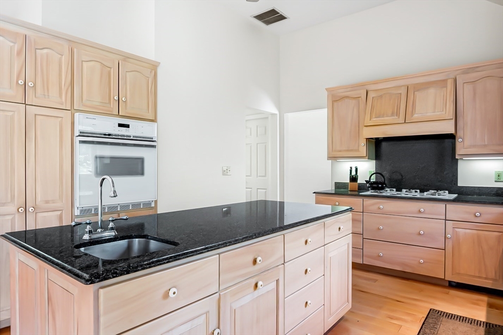 7 Bray Street Gloucester, MA 01930 - Photo 3 of 26 a kitchen with granite countertop white cabinets and a sink