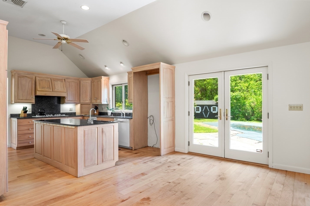 7 Bray Street Gloucester, MA 01930 - Photo 5 of 26 a kitchen with stainless steel appliances granite countertop a refrigerator and a stove top oven