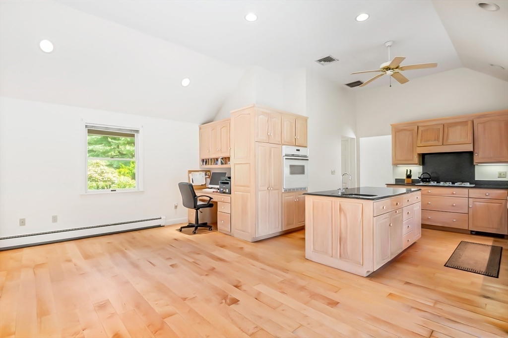 7 Bray Street Gloucester, MA 01930 - Photo 6 of 26 a large white kitchen with a stove a sink dishwasher and a refrigerator with wooden floor