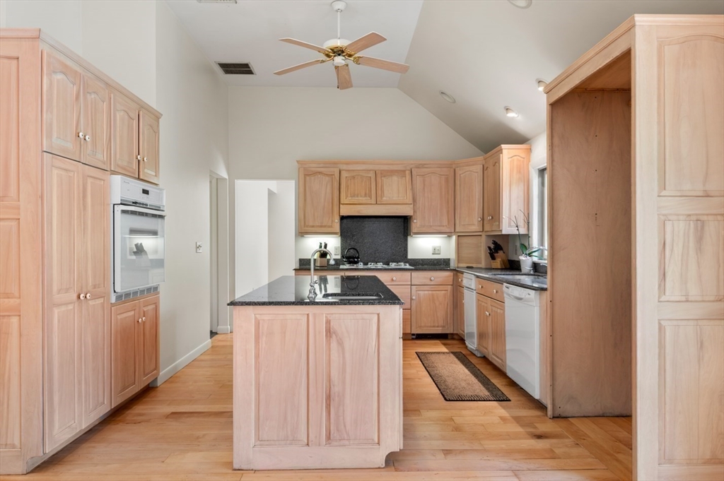 7 Bray Street Gloucester, MA 01930 - Photo 7 of 26 a kitchen with white cabinets and refrigerator