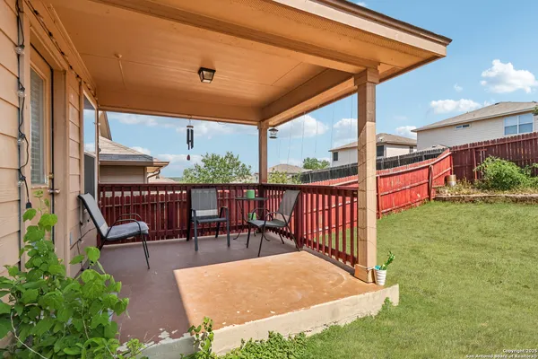 a view of a house with a yard and sitting area