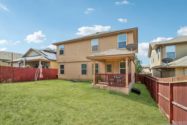 a view of a house with a yard and sitting area