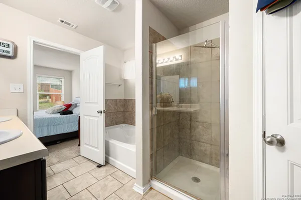 a en suite bathroom with a sink and a mirror