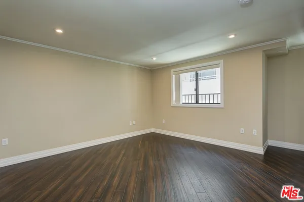 a view of a room with wooden floor and windows