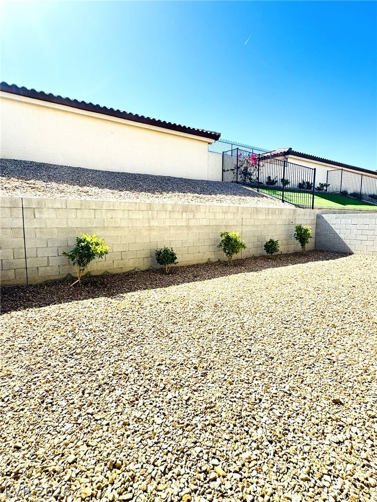 4457 Sawyer Ridge Street Las Vegas, NV 89147 - Photo 32 of 32 A tiered landscape of gravel and retaining walls defines this low-maintenance outdoor space.