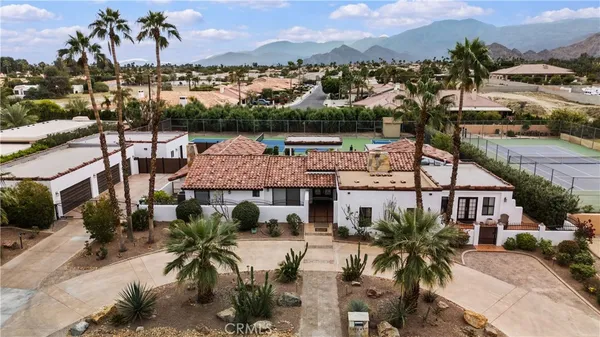 an aerial view of multiple houses with a yard