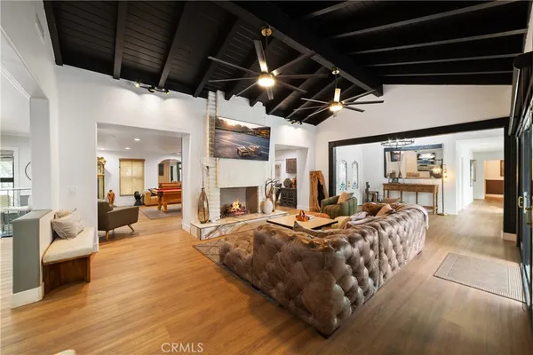 a living room with furniture fireplace and a window
